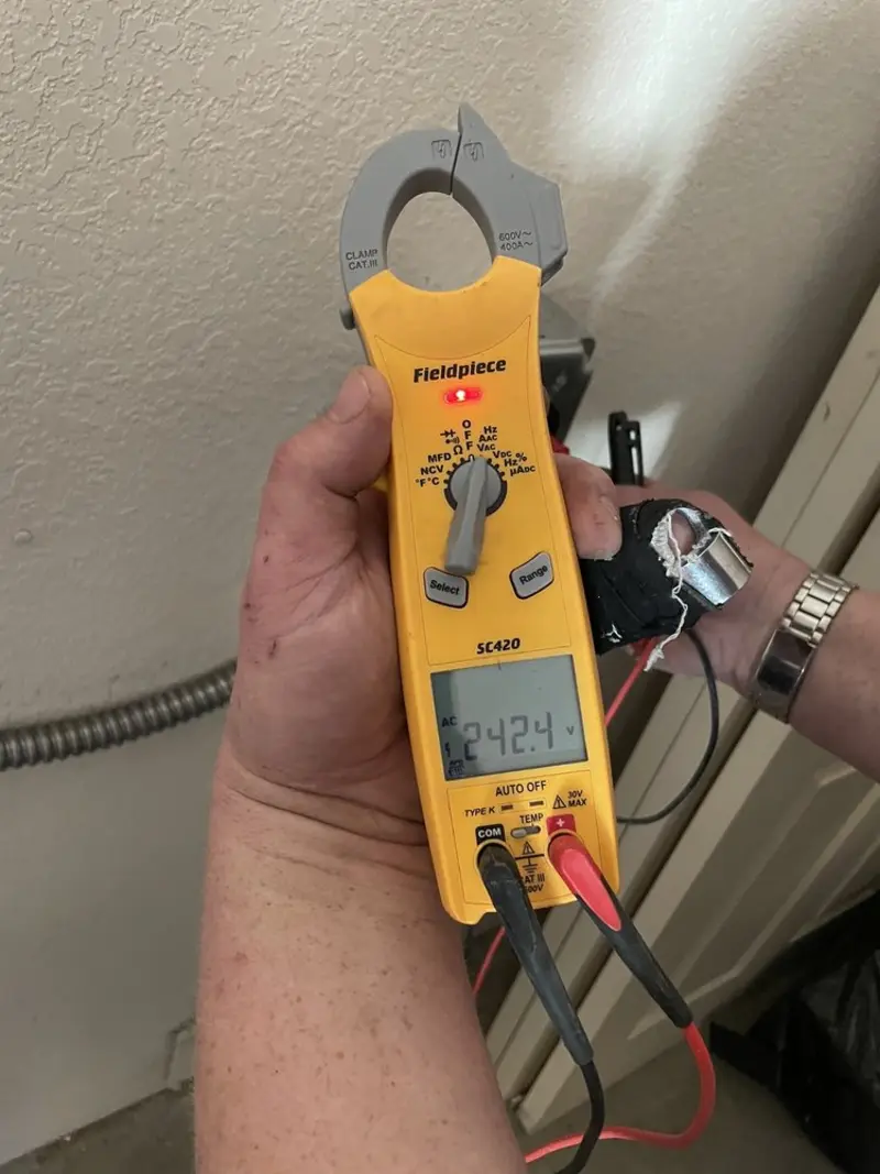 Voltage testing with clamp meter during Recessed Lighting Installation in Middle